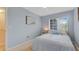 A cozy bedroom painted blue with a lovely window allowing for natural light and nice furniture at 18148 Nassau Point Dr, Tampa, FL 33647
