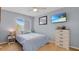 A cozy bedroom painted blue with a lovely window allowing for natural light and nice furniture at 18148 Nassau Point Dr, Tampa, FL 33647