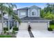Charming townhome featuring a two-car garage and tropical landscaping at 18148 Nassau Point Dr, Tampa, FL 33647