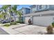 Exterior of townhomes with attached garages, lovely landscaping and well-maintained sidewalks at 18148 Nassau Point Dr, Tampa, FL 33647