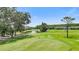 Picturesque golf course view featuring lush green fairways and a tranquil pond at 18148 Nassau Point Dr, Tampa, FL 33647