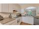 Bright kitchen with white cabinets, granite counters, and stainless appliances at 18148 Nassau Point Dr, Tampa, FL 33647