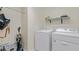 Bright laundry room with modern appliances and shelving for storage and organizing at 18148 Nassau Point Dr, Tampa, FL 33647