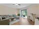 Open-concept living room with sliding doors to lanai and a charming bar area at 18148 Nassau Point Dr, Tampa, FL 33647