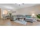 Inviting living room featuring a large sectional couch and wood-look flooring at 18148 Nassau Point Dr, Tampa, FL 33647