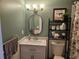 Charming bathroom with stylish fixtures, updated vanity, and decorative shelving at 1833 Bough Ave # 2, Clearwater, FL 33760