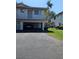 Inviting two-story condo featuring an open carport, second story balcony, and well-maintained landscaping at 1833 Bough Ave # 2, Clearwater, FL 33760