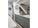 Bright kitchen features stainless steel sink, updated cabinetry, and a view of the staircase at 1833 Bough Ave # 2, Clearwater, FL 33760