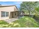 A well-maintained backyard shows a patio and screened lanai area, ideal for relaxation and outdoor activities at 18967 Wood Sage Dr, Tampa, FL 33647