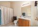 Neutral bathroom with a shower-tub combo, single sink vanity, and tile flooring at 18967 Wood Sage Dr, Tampa, FL 33647