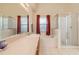 Bright bathroom featuring a soaking tub, glass-enclosed shower, and a spacious vanity with ample counter space at 18967 Wood Sage Dr, Tampa, FL 33647