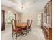 Traditional dining room featuring a wood table, six chairs, and large window for natural light at 18967 Wood Sage Dr, Tampa, FL 33647