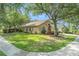 Charming house showcasing a well-kept lawn, mature trees, and curb appeal in a quiet residential area at 18967 Wood Sage Dr, Tampa, FL 33647