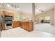 Bright kitchen with stainless appliances and a pass-through view to the cozy living room at 18967 Wood Sage Dr, Tampa, FL 33647