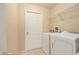 Laundry room with a washer, dryer, and a wire rack shelving unit at 18967 Wood Sage Dr, Tampa, FL 33647