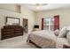 Comfortable main bedroom featuring a large dresser and an ensuite bathroom at 18967 Wood Sage Dr, Tampa, FL 33647