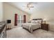 Inviting primary bedroom with a queen bed, soft carpeting, and ample natural light at 18967 Wood Sage Dr, Tampa, FL 33647