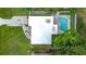 Aerial view of home with a pool, nice backyard and a large tree at 1921 Ridgewood Dr, Clearwater, FL 33763