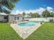 Backyard featuring a pool and outdoor seating at 1921 Ridgewood Dr, Clearwater, FL 33763