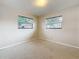 A naturally lit bedroom featuring two windows at 1921 Ridgewood Dr, Clearwater, FL 33763