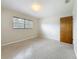 Cozy bedroom with neutral walls, carpet flooring, and a window offering ample natural light at 1921 Ridgewood Dr, Clearwater, FL 33763