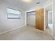 Bedroom features a window and an open closet at 1921 Ridgewood Dr, Clearwater, FL 33763