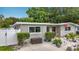 Exterior view of a well-maintained home with tidy landscaping and walkway at 1921 Ridgewood Dr, Clearwater, FL 33763