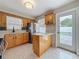 Open-concept kitchen with stainless steel fridge and door leading to the outdoor pool area at 1921 Ridgewood Dr, Clearwater, FL 33763