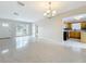 Spacious living area featuring terrazzo floors and an open layout to the kitchen at 1921 Ridgewood Dr, Clearwater, FL 33763