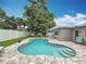 Relaxing backyard with a spacious pool, patio area, and lush green lawn at 1921 Ridgewood Dr, Clearwater, FL 33763