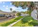 Expansive backyard featuring a putting green, patio seating, and lush landscaping at 1960 Sever Dr, Clearwater, FL 33764