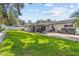 Lush backyard with a covered patio, perfect for enjoying outdoor living and entertaining at 1960 Sever Dr, Clearwater, FL 33764