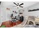 Spacious bedroom with hardwood floors, ceiling fan, and a wall of unique décor at 1960 Sever Dr, Clearwater, FL 33764