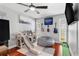 Bedroom features a ceiling fan, hardwood floors, playset, and wall décor at 1960 Sever Dr, Clearwater, FL 33764
