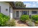 Close up of the inviting front entrance with manicured bushes and a charming brick walkway at 1960 Sever Dr, Clearwater, FL 33764