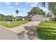 Inviting home exterior with a spacious driveway, green lawn, and well-maintained landscaping at 1960 Sever Dr, Clearwater, FL 33764