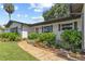 Charming home with well-maintained landscaping, vibrant plants, and a welcoming walkway to the front door at 1960 Sever Dr, Clearwater, FL 33764