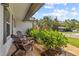 Cozy front porch with two wooden Adirondack chairs surrounded by lush greenery, perfect for relaxing at 1960 Sever Dr, Clearwater, FL 33764