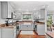 Well-designed kitchen featuring white cabinets, granite countertops, and stainless steel appliances at 1960 Sever Dr, Clearwater, FL 33764