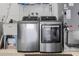 Laundry room featuring a new stainless steel washer and dryer set, next to a utility sink at 1960 Sever Dr, Clearwater, FL 33764