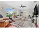 Inviting living room with a sectional sofa, hardwood floors, and ample natural light at 1960 Sever Dr, Clearwater, FL 33764