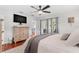 Comfortable main bedroom featuring a ceiling fan, a dresser, wood flooring, and natural light at 1960 Sever Dr, Clearwater, FL 33764