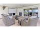 Relaxing covered patio with comfortable wicker furniture and a mounted projector screen for outdoor entertainment at 1960 Sever Dr, Clearwater, FL 33764