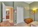 Bedroom with an open bathroom, closet, and neutral carpet at 2015 Long Branch Ln, Clearwater, FL 33760