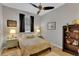 Cozy bedroom features a ceiling fan, tile flooring, and neutral paint at 2015 Long Branch Ln, Clearwater, FL 33760