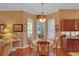 Bright breakfast nook with hardwood floors, dining table, and exterior door at 2015 Long Branch Ln, Clearwater, FL 33760