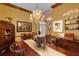 Spacious dining room with chandelier, dark wood floors, and antique furniture at 2015 Long Branch Ln, Clearwater, FL 33760