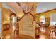 Warm and inviting foyer with hardwood floors and staircase leading to the upper level, offering seamless access to rooms at 2015 Long Branch Ln, Clearwater, FL 33760
