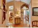 Inviting hallway with hardwood floors leading to dining room and living room, showcasing an open and flowing floor plan at 2015 Long Branch Ln, Clearwater, FL 33760