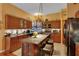 Spacious kitchen with granite countertops, dark wood cabinetry, and bar seating at 2015 Long Branch Ln, Clearwater, FL 33760